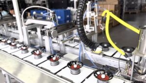 Wholesale car audio products in a warehouse with speakers and amplifiers.